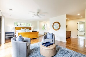 A spacious bedroom with a wooden bed, a ceiling fan, a large window, and a view of the outdoors. - New Luxury Waterfront Retreat with Pool, Private Pier & Multiple EnSuite King Bedrooms (Annapolis)