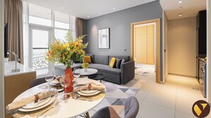 A modern living room with a grey sofa, a dining table set with plates and glasses, and a large window with curtains. - Vogue | JVT near Springs Souk Mall (Dubai)