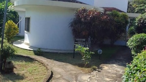 A two-story white house with a stone pathway leading to the entrance. - Capital Comfort Hotel (Nairobi)