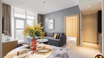 Luxury Apartment, Balcony, City View | Living area | 65-inch Smart TV with cable channels