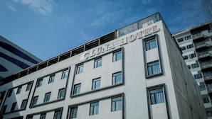 A hotel building with a sign reading 'LUNA HOTEL' on the facade.