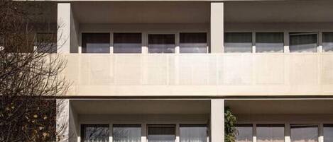 A multi-story building with a flat facade, large windows, and a uniform design.