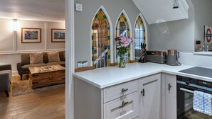 A modern kitchen with white cabinetry, a built-in oven, and a coffee machine. - Stunning  villa for 8 people with WIFI (Cawsand)
