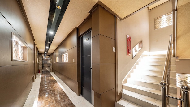 A hotel corridor with a marble floor, a staircase, and a door marked "Exit". - Hotel Hue (Incheon)