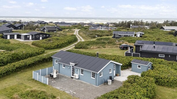 A coastal residential area with houses, a clear sky, and a view of the ocean. - "Gjuro" - 400m from the sea by Interhome (Hjørring)