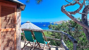 A wooden building with a balcony overlooking a coastal view.