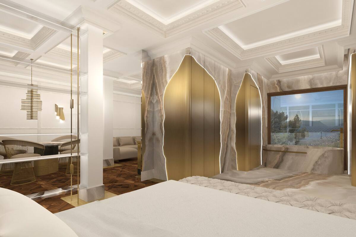 Een moderne slaapkamer met een groot bed, een zithoek met stoelen, een bank en een groot raam met uitzicht.