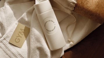 A white water bottle with a label on a towel.