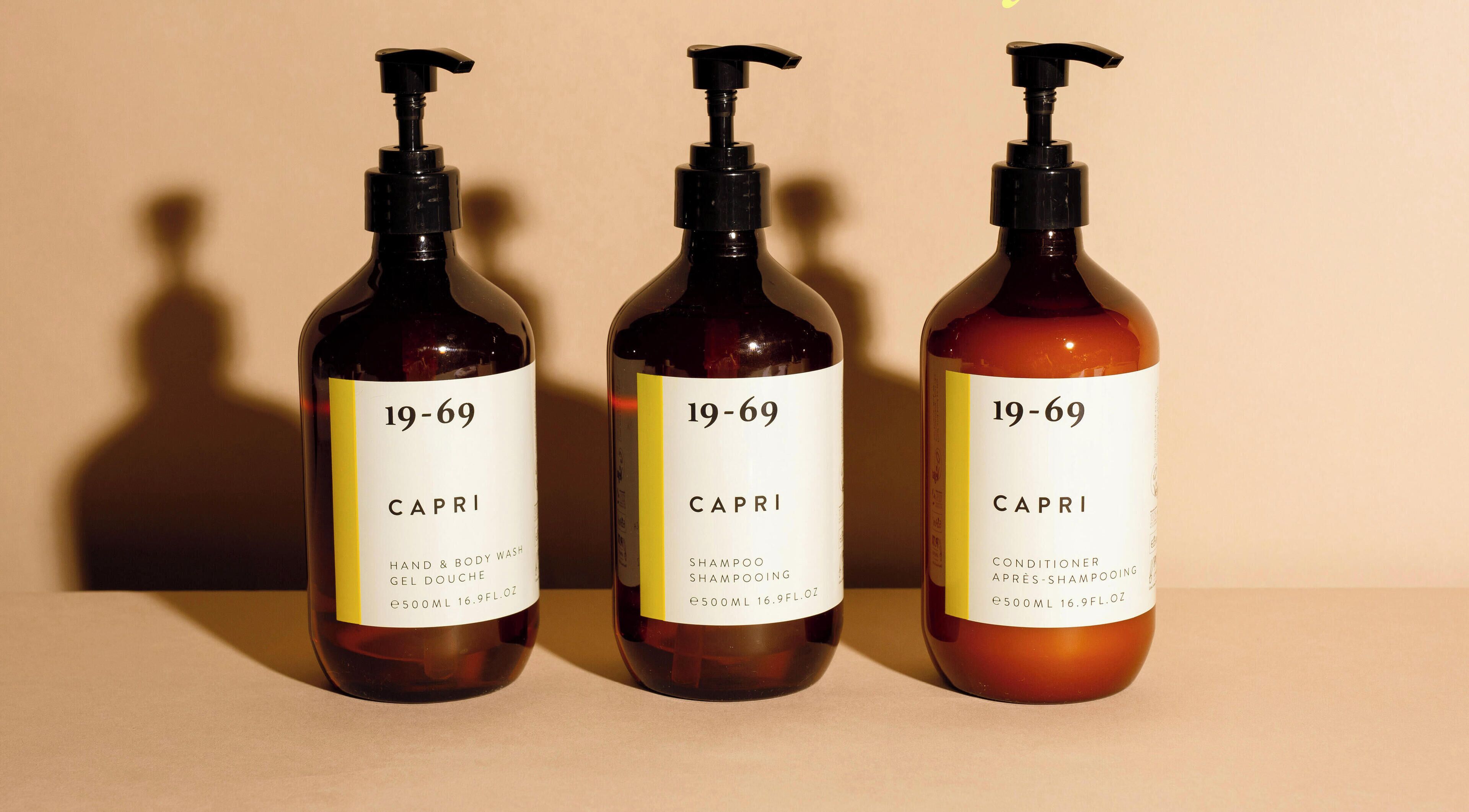 Three bottles of Capri hand and body wash, shampoo, and conditioner.