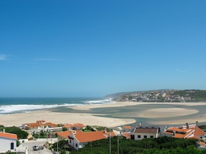 A coastal town with buildings on a hillside, a beach, and the ocean. - Luxuriöse Villa nur wenige Schritte vom Strand entfernt by Interhome (Obidos)