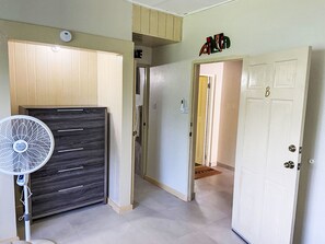 A hallway with a fan, a door marked with a 'B', and a sign above the door. - Ramparts Apartment "Peaceful Escape" in Flughafennähe by Interhome (Belleair)