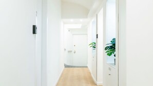 A narrow hallway with white walls and wooden flooring. - Turin Central Carlo Felice (Turin)