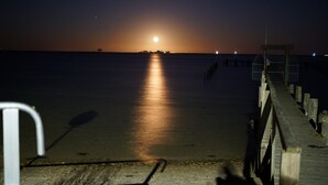 A pier extending into calm waters at night with a moonlit sky. - Pamir - View of the river, terrace, garden, induction stove, parking space (Olpenitzdorf)