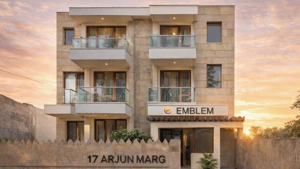 A modern multi-story building with a sign reading "EMBLEM" and a nameplate "17 ARJUN MARG". - EMBLEM Hotel – Arjun Marg, Golf Course Road Gurgaon (Gurugram)