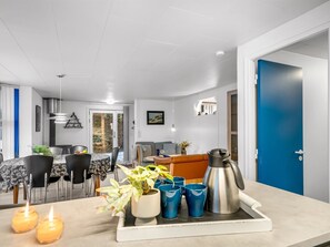 A modern kitchen with a dining area, featuring a coffee maker, cups, and candles on the counter. - "Allyson" -  from the sea by Interhome (Hadsund)