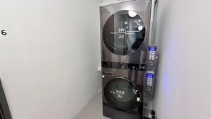 A compact, modern laundry machine with a digital display, a 16 kg dry cycle, and a 21 kg wash cycle. - Brown H (Bangkok)