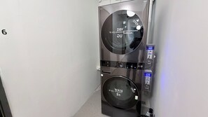 A compact, modern laundry machine with a digital display, a 16 kg dry cycle, and a 21 kg wash cycle. - Brown H (Bangkok)