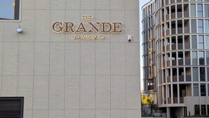 A building with a sign reading "The Grande 68-72 Allara St." - Centrally located new apartment with free parking and access of pool , gym (Canberra)