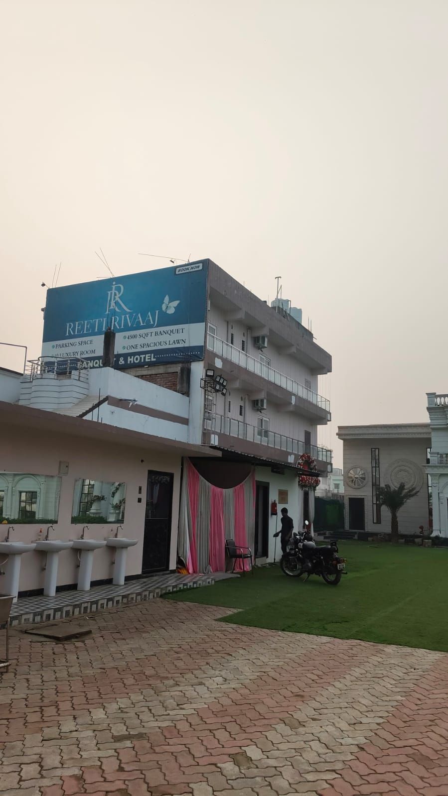 A hotel with a signboard advertising parking space, a luxury room, and a banquet area.