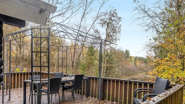 An outdoor deck with a pergola, a table, and chairs. - "Kerrin" by Interhome (Aars)