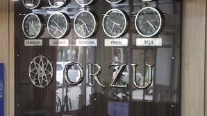 A wall with clocks labeled with city names and the word "ORZU". - Orzu Hotel (Namangan)