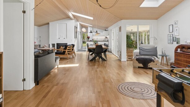 A spacious loft with a high ceiling, wooden flooring, a dining area, a living room with a sofa, and a kitchen with a view. - "Aiko" - 1.8km from the sea by Interhome (Højby)