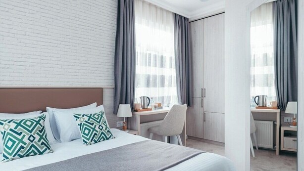 A hotel room with a bed, a desk, and a chair. - Citrus Boutique Hotel (Baku)