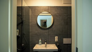 A bathroom with a sink, mirror, and shower. - Moderne City Zimmer mit eigenem Bad (Bamberg)