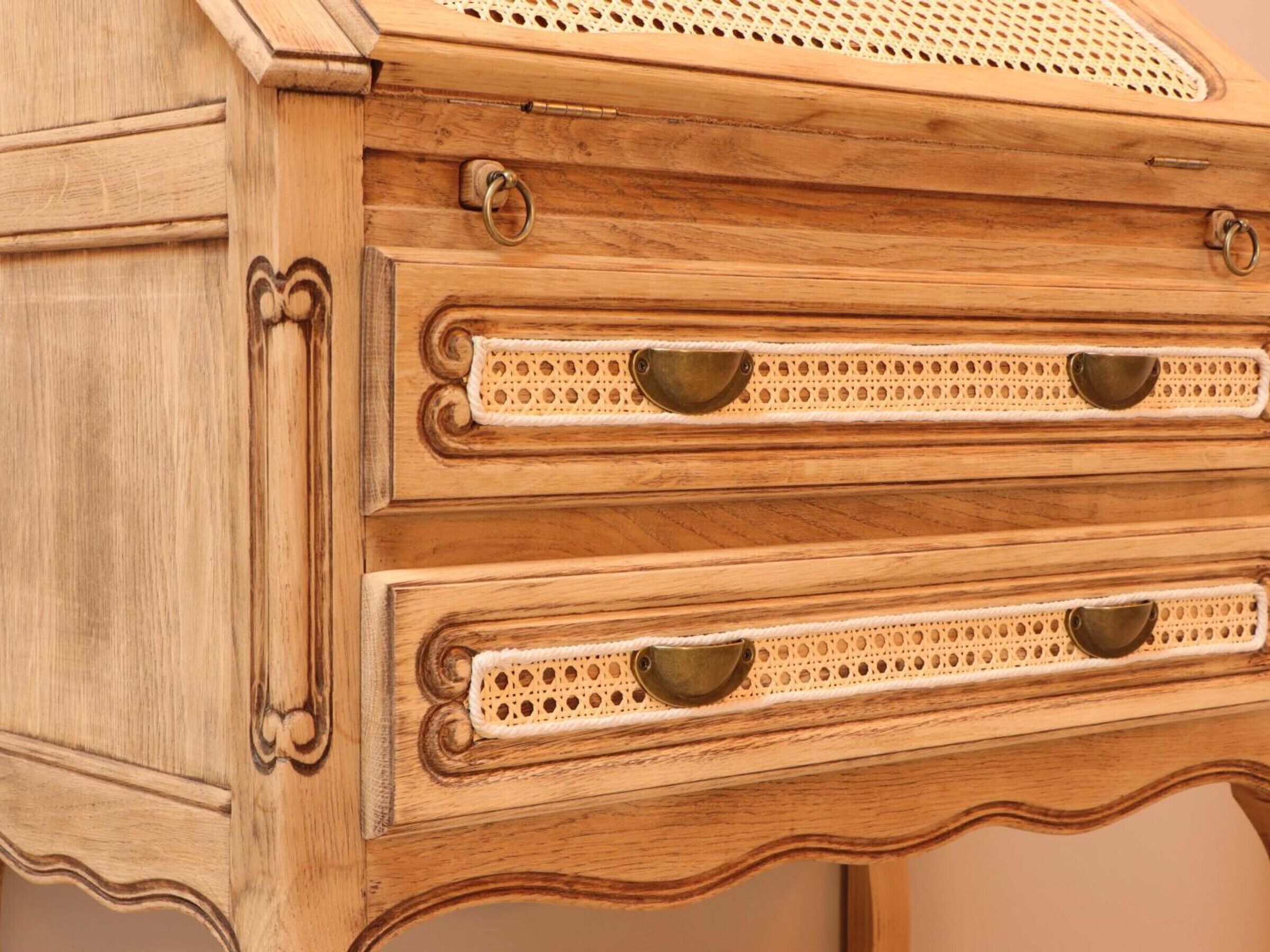 A wooden dresser with two drawers, each featuring a perforated handle.
