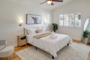A bedroom with a bed, bedside tables, a ceiling fan, a window with blinds, and a wall-mounted picture. - Extended Stay Home w/ Mtn View: 5 Mi to The Strip! (Las Vegas)