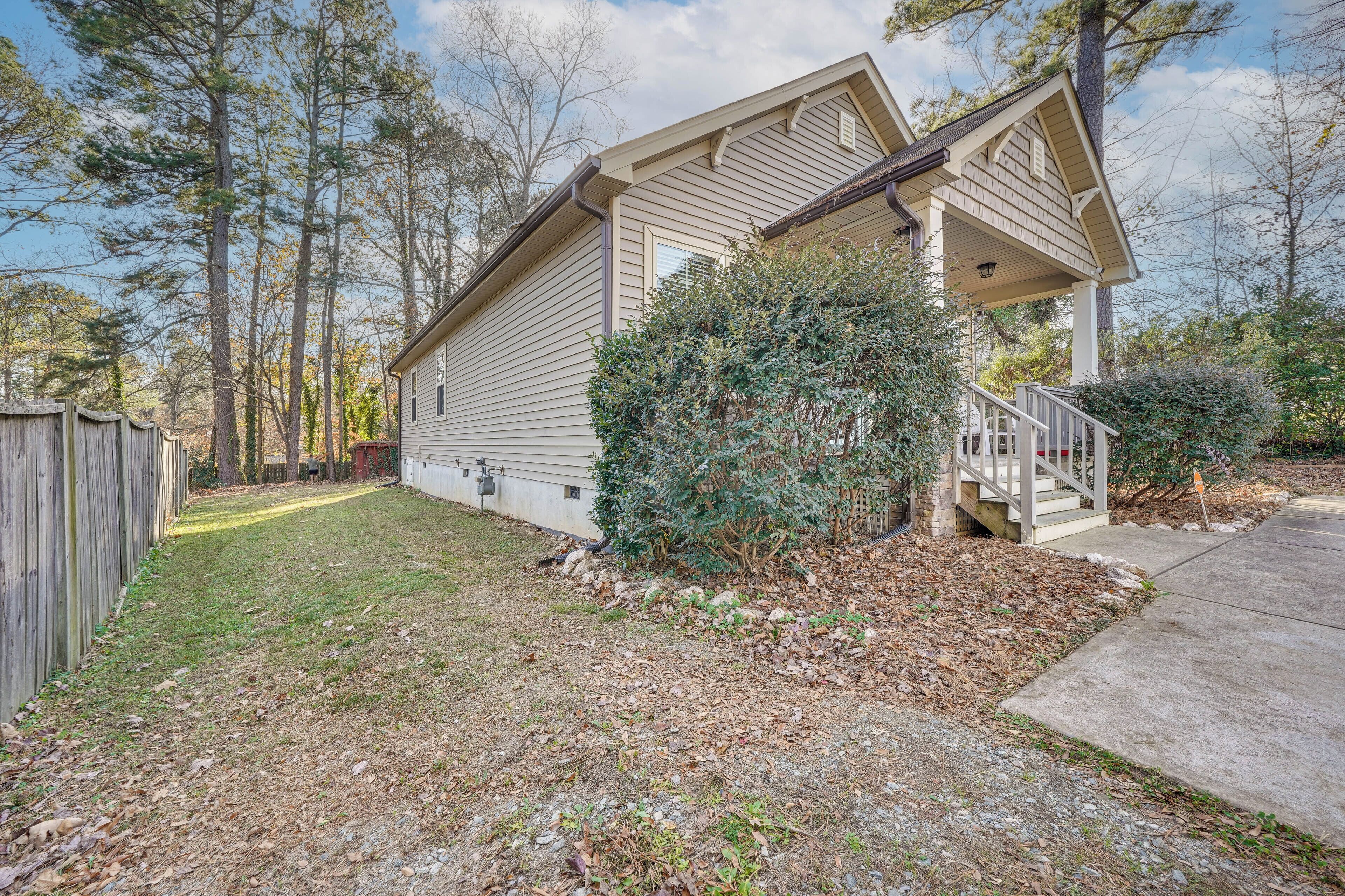 A single-story house with a front porch, a small attached garage, and a well-maintained lawn.