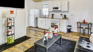 A modern kitchen with white cabinets, a microwave, and a stove. There are decorative snowmen and a Christmas tree on the counter. - 1 Mi to Dtwn Enterprise: Pet-friendly Home w/ Yard (Enterprise)