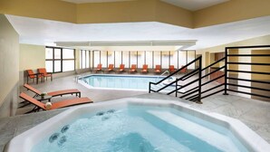 A hotel room with a large indoor pool, sun loungers, and a hot tub. - Near Mt. Crested Butte + Skiing. Dining. Spa. (Mt. Crested Butte)