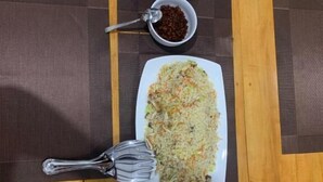 A dining table with three plates of food, each with a spoon. - Rivers Edge Resort Sinharaja (Weddagala)