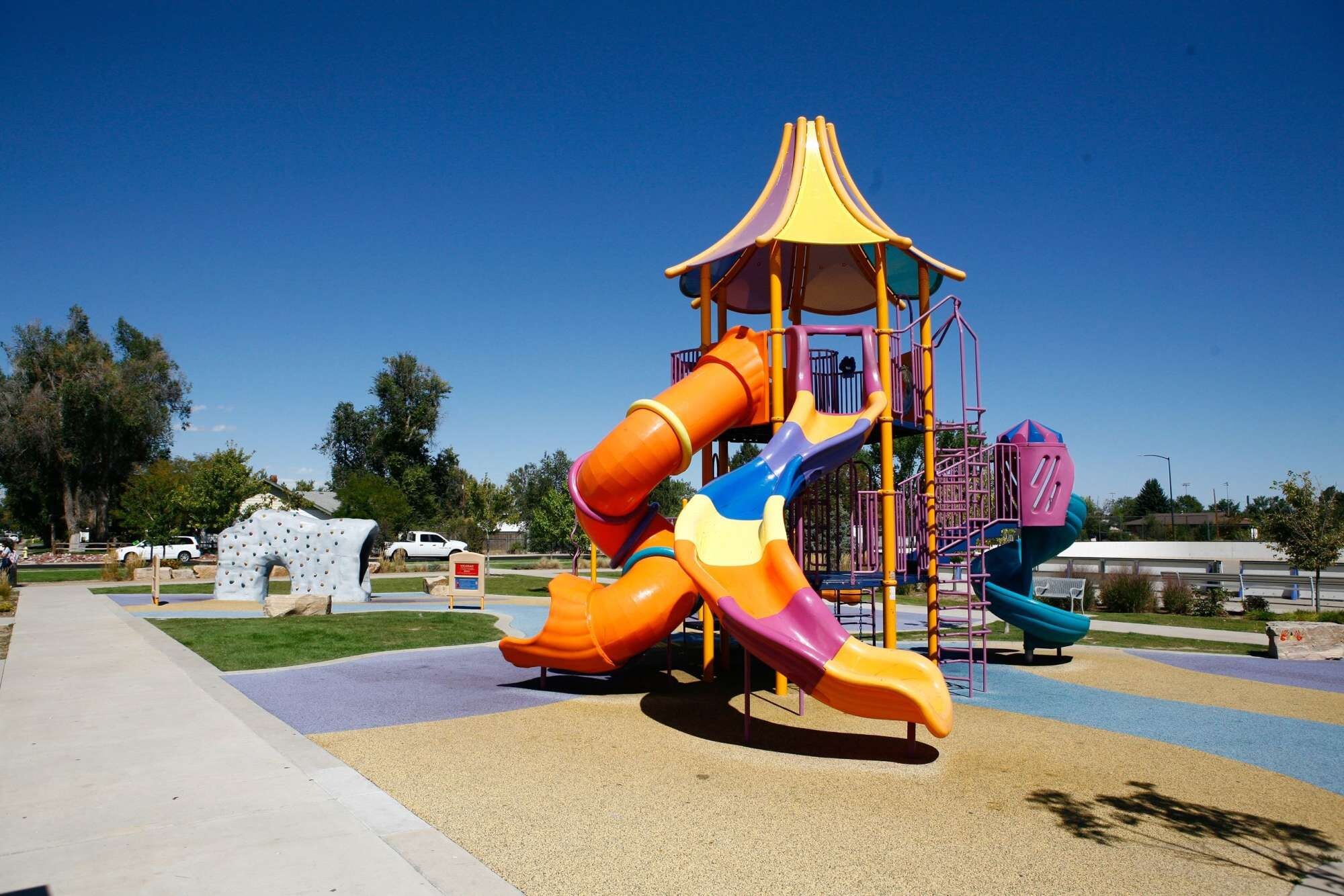 A playground with multiple slides and a climbing structure.