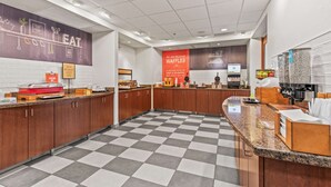A modern kitchen with checkered flooring, wooden cabinets, and a central island.