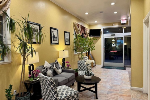 Cozy sitting area with plants and couch near the entrance