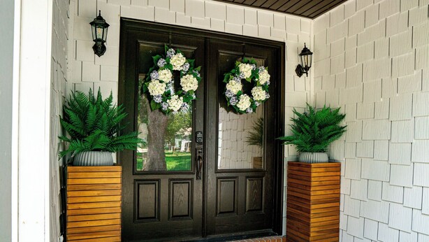 A front door with two large wreaths, a wooden planter on each side, and a 'hello' mat at the entrance. - Welcome to Your Fairhope Getaway! (Fairhope)