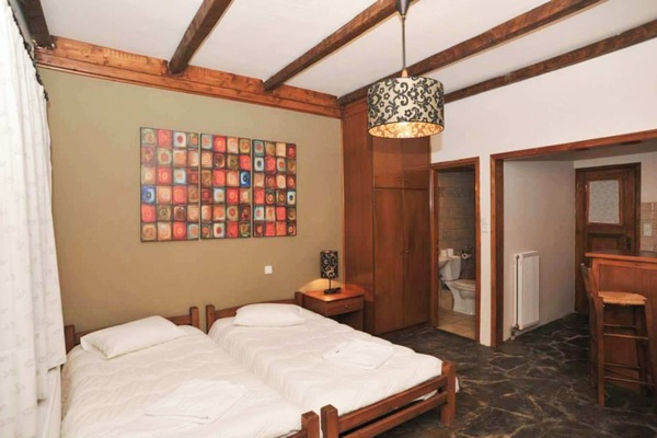 Warm, traditional mountain-style bedroom designed for deep rest after a day in nature.
