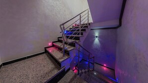 A staircase with metal railings and a handrail, leading to an upper floor. - House Aisha (Tamraght)