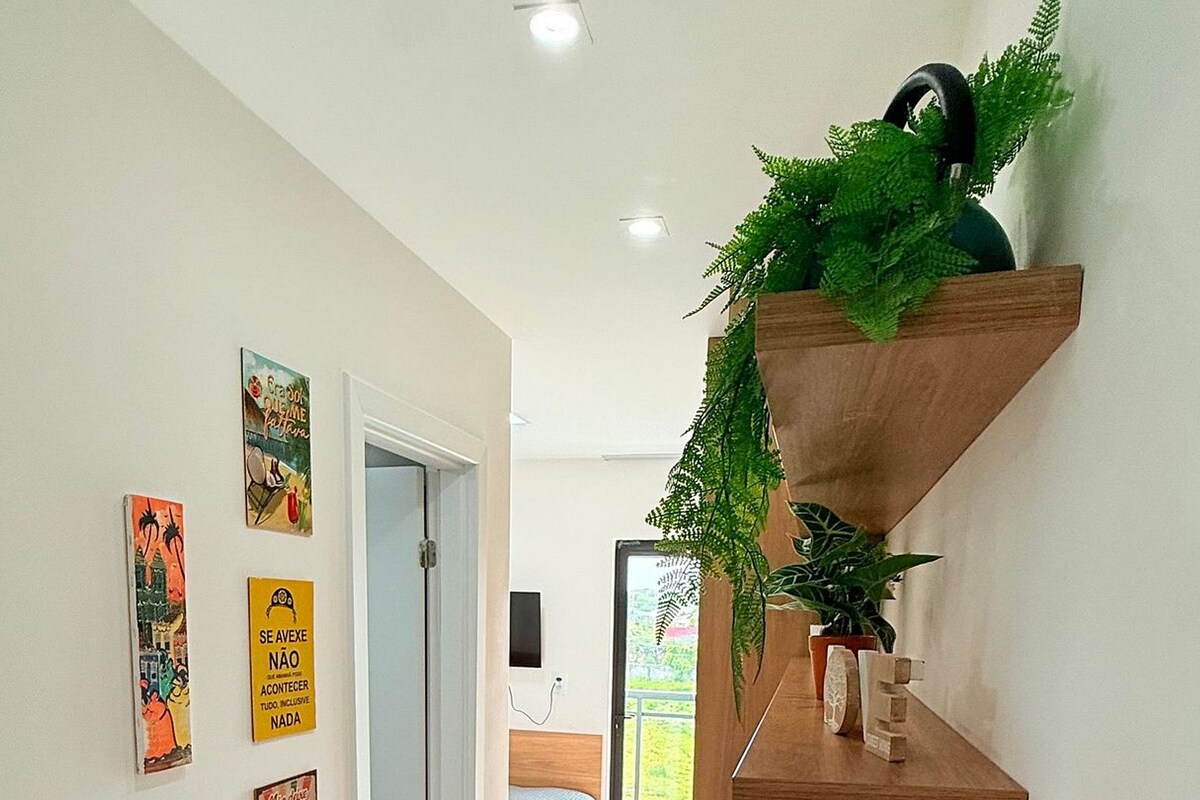 A modern interior with a wooden counter, decorative wall art, and a door leading to a balcony.