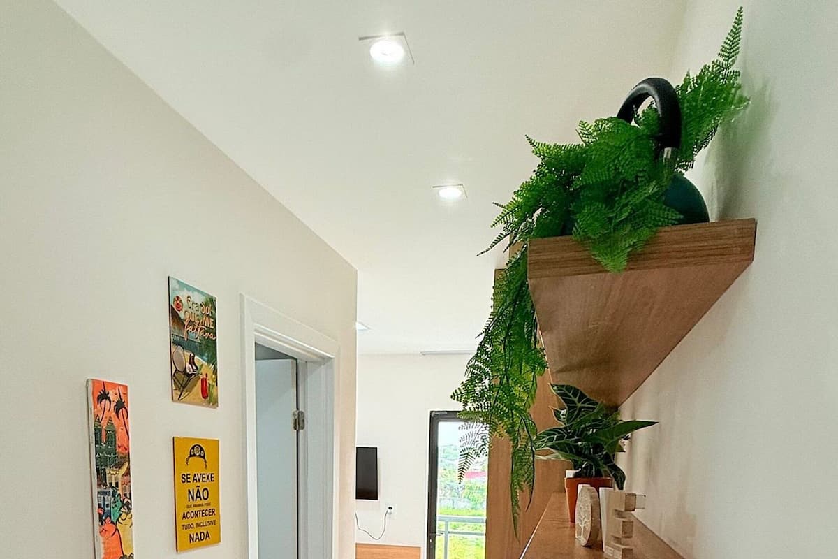 A modern interior with a wooden counter, decorative wall art, and a door leading to a balcony.