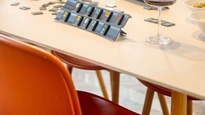 A dining table with a board game, two wine glasses, and candles. - Bright 2BR Flat in Antwerp City (Antwerpen)