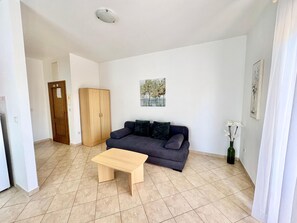 A living room with a sofa, a wooden coffee table, a wardrobe, and a painting on the wall. - Apartments Cukon (16136-A3) - Medulin (Medulin)