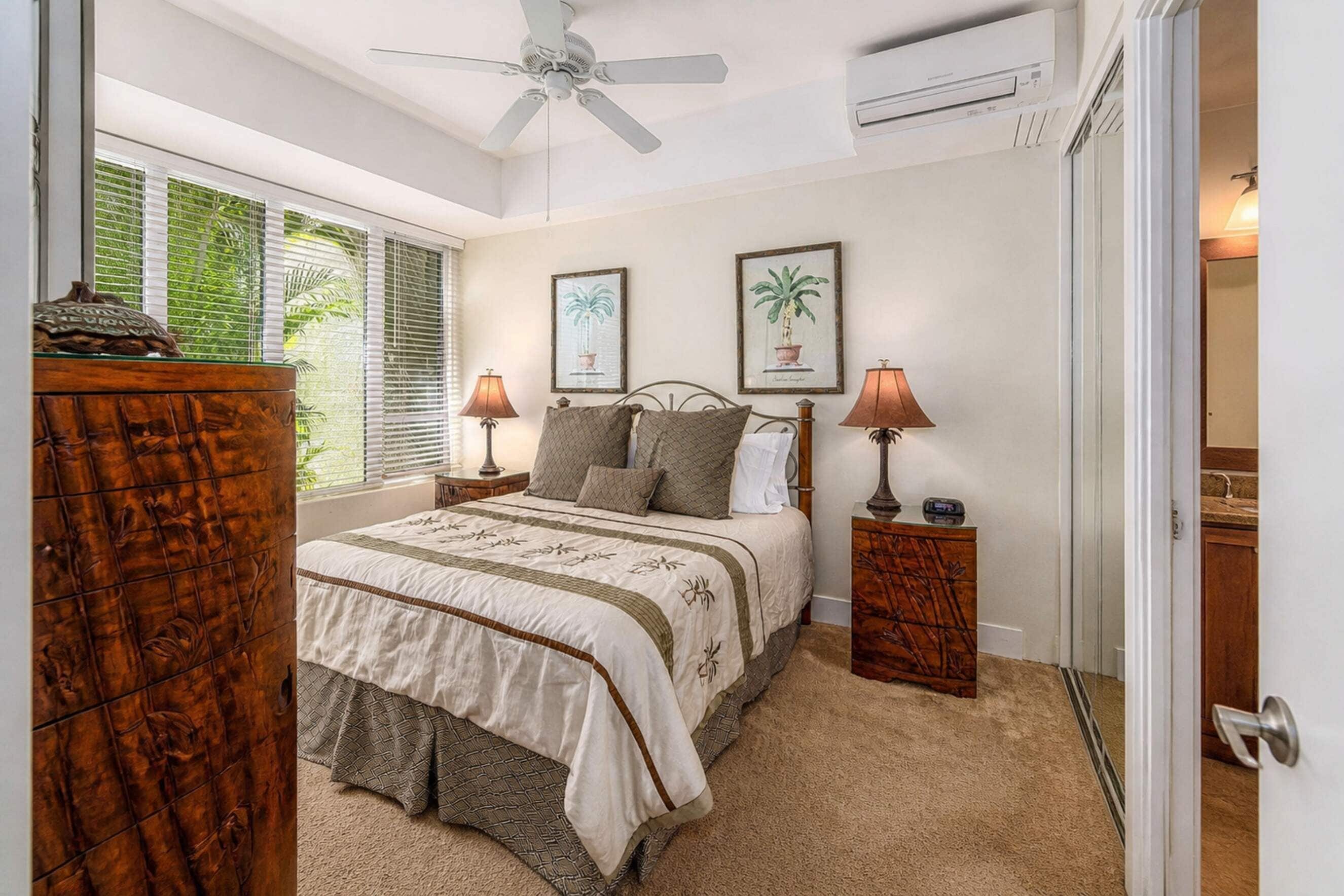 A bedroom with a bed, two bedside tables, a ceiling fan, and a window with blinds.