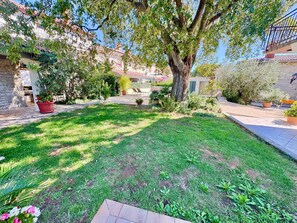 A well-maintained garden with a variety of plants and a paved pathway. - Apartments Ladonia (16296-A3) - Krnica (Pula) (Krnica (Pula))