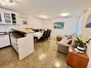 A compact living space with a kitchen, dining area, and seating area. - Apartments Ladonia (16296-K1) - Krnica (Pula) (Krnica (Pula))