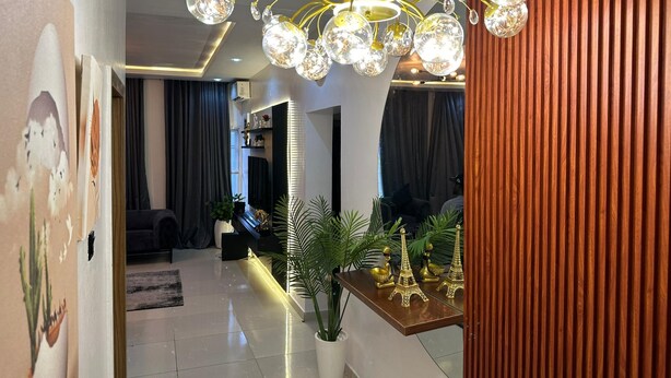 A modern living room with a chandelier, a sofa, a coffee table, and decorative items. - 3 Bedroom En-Suite, Wi-Fi, Secured, 24/7 Power (Lekki)