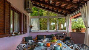 Un coin repas avec une table mise pour le petit-déjeuner, comprenant des fruits, des viennoiseries et des boissons.