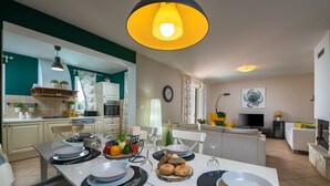 A modern kitchen with a dining area, featuring a central island, pendant lighting, and a view into the living room. - Villa Laura (16946-K1) - Krnica (Pula) (Krnica (Pula))